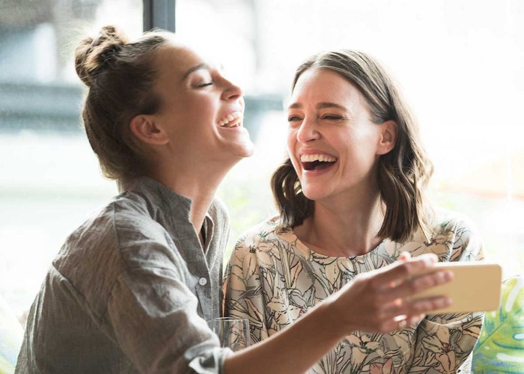 Young female adults laughing