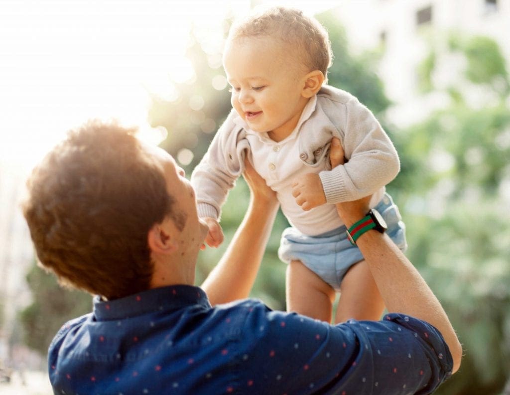 father holding baby